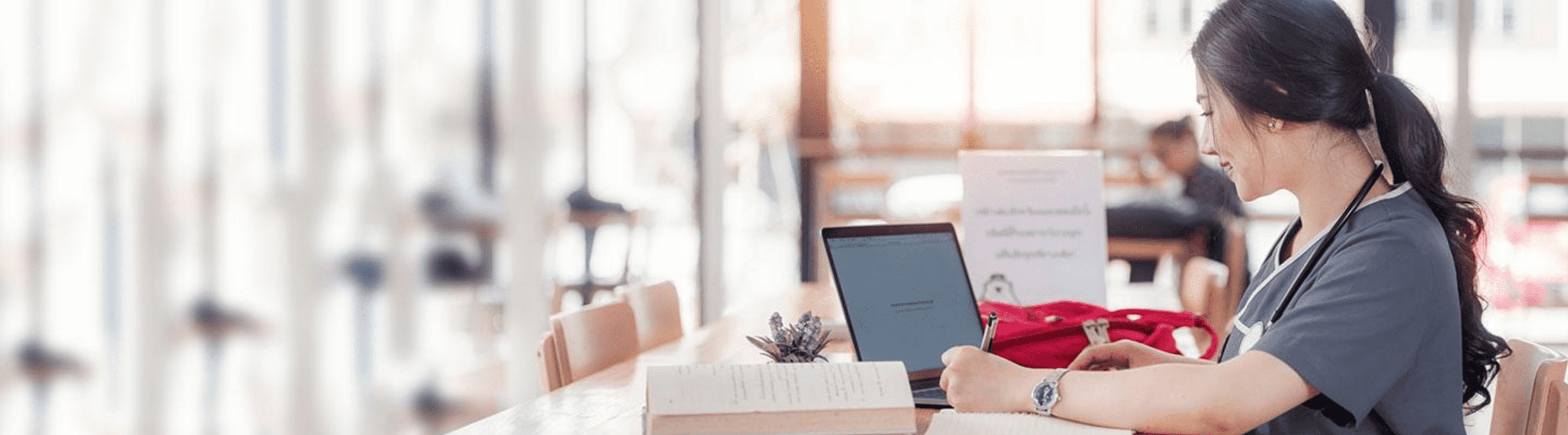 Online nursing student studying with her laptop.